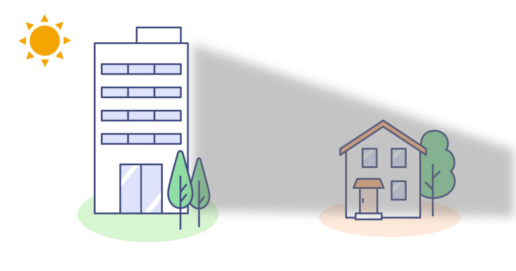 ビルで家が影になっているイラスト