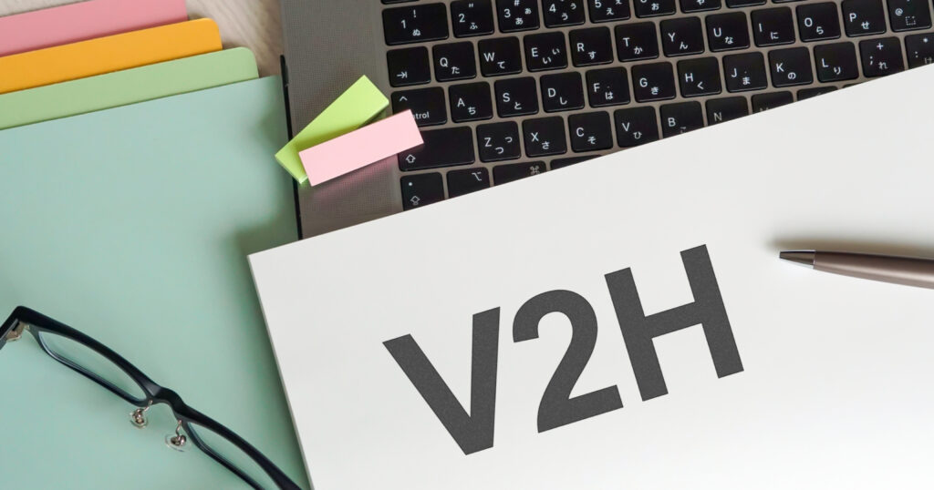 パソコンとV2Hと書かれた紙の写真。